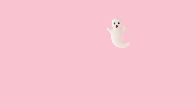 White ghost flying down on pink background. Minimal Halloween concept.