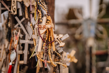 A large collection of wooden crosses, crucifixes, and rosaries displayed at Kryžių Kalnas (Hill...