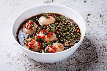 Korean marinated eggs in soy sauce with sesame and onions.