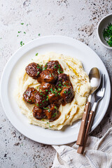 Beef meatballs in creamy sauce with mashed potatoes.