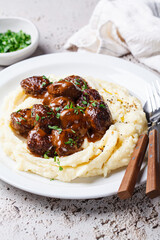 Beef meatballs in creamy sauce with mashed potatoes.