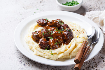 Beef meatballs in creamy sauce with mashed potatoes.