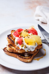 French toast with cream and citrus slices.