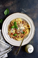 Traditional italian spaghetti bolognese with tomatoes and minced meat. Top view with copy space.