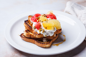 French toast with cream and citrus slices.