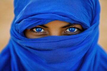 Naklejka premium Portrait of Berber Person in Blue Clothes in Sahara Desert