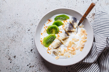 Greek yogurt with kiwi, banana, chia and coconut chips.