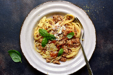 Traditional italian spaghetti bolognese with tomatoes and minced meat. Top view with copy space.