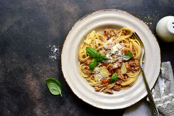 Traditional italian spaghetti bolognese with tomatoes and minced meat. Top view with copy space.