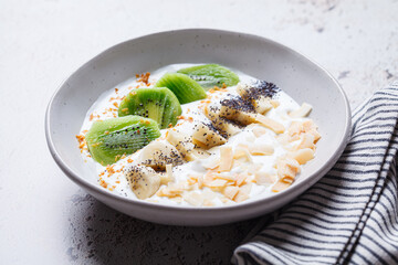Greek yogurt with kiwi, banana, chia and coconut chips.