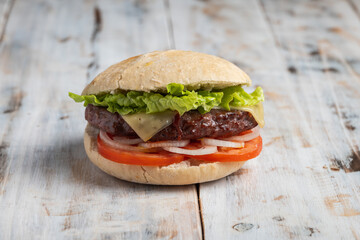 Hamburger with lettuce, tomato, cheese and onion