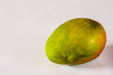 Ripe single mango fruit studio photo isolated with text space