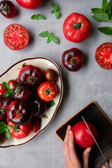 High-resolution image of fresh, juicy red tomatoes with water droplets on a clean background. This photo is perfect for promoting organic produce, healthy food, or farm-to-table concepts. 