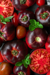 High-resolution image of fresh, juicy red tomatoes with water droplets on a clean background. This photo is perfect for promoting organic produce, healthy food, or farm-to-table concepts. 