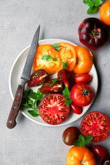 High-resolution image of fresh, juicy red tomatoes with water droplets on a clean background. This photo is perfect for promoting organic produce, healthy food, or farm-to-table concepts. 