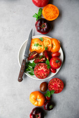 High-resolution image of fresh, juicy red tomatoes with water droplets on a clean background. This photo is perfect for promoting organic produce, healthy food, or farm-to-table concepts. 