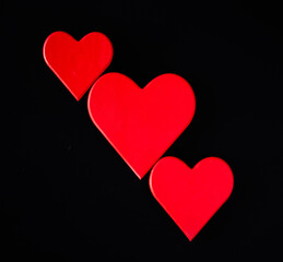 Three Blank red hearts on a black background