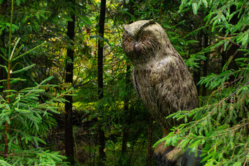 a large stuffed owl on a branch