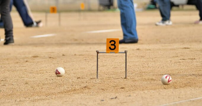 blurred people playing gateball game on the ground,famous sport in Japanese senior social, selective focus shot