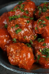 meatballs with tomato sauce and decorated with parsley