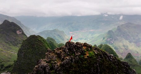 Vietnam Flag on top of mountain. Aerial backward