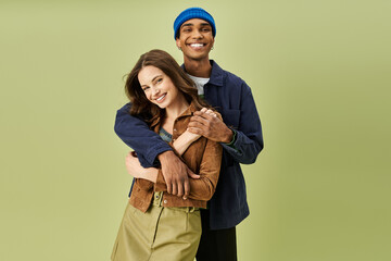 A stylish couple shares a light hearted moment showcasing their trendy autumn outfits together.