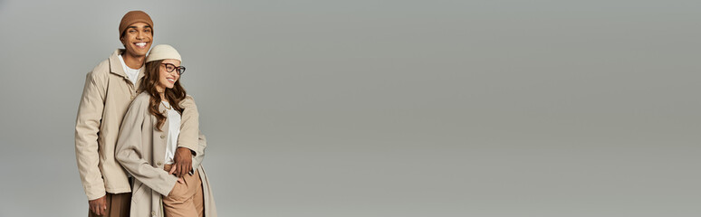 A fashionable couple enjoys each others company while showcasing vibrant autumn outfits.