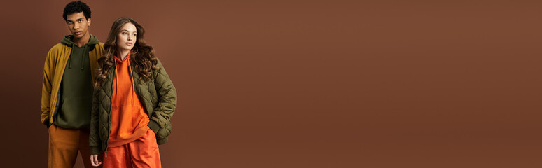 A stylish pair showcases their colorful autumn attire while enjoying the seasons charm.