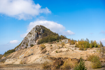 Abandoned and closed barite mine on Bobija mountain in Western Serbia, near the town of Valjevo. Remains of ruined nature with a tailings dump and a toxic lake with copper-colored water.