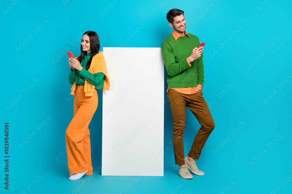 Poster full size photo of two bloggers advertise new technology search menu smartphone isolated on blue col