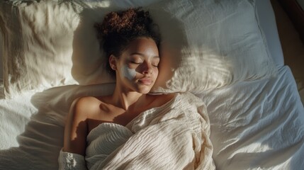 2410 9.Overhead view of a woman with vitiligo sleeping comfortably in bed, her arms visible above the blanket, showing distinct white patches on her skin. The natural morning light enhances the soft,