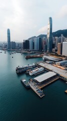Obraz premium Aerial view of hong kong skyline with ferries docked at pier on victoria harbour