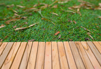 wooden table on green grass background