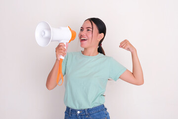 A woman showing her arm muscle while announce something using megaphone