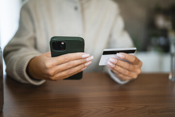 Adult woman use smart phone for online shopping transaction safely