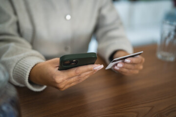 Adult woman use smart phone for online shopping transaction safely