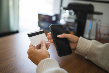 Adult woman use smart phone for online shopping transaction safely