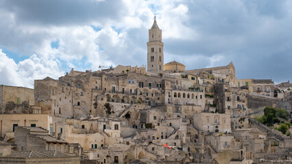Obraz premium Exploring the ancient architecture of Matera in Puglia, Italy under a dramatic cloud filled sky