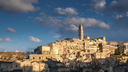 Breathtaking sunset illuminates the ancient stone city of Matera, Puglia with historical charm
