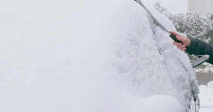 Winter Driving - Removing snow from a snow-covered car on a foggy winter morning - Slow-mo