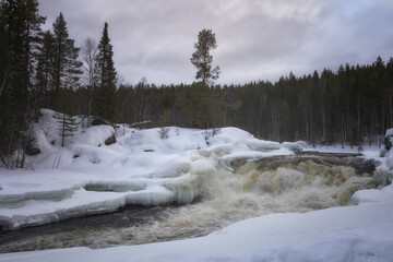 Winter landscape with a waterfall and snow. Russia, Karelia