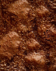Baked cracked brownie surface textured background. Selective focus. Sweet food bakery concept. Selective focus.