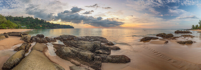 Tropical sea beach sunset with rock coast and ocean wave at Khao Lak, Phang Nga Thailand nature landscape panorama