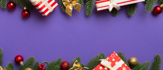 Christmas decorations and fir tree branch and gift boxon dark table. Top view frame with copy space