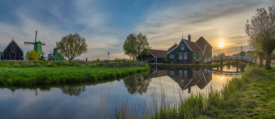 Obraz premium Dutch Windmill and traditional house panorama sunrise at Zaanse Schans Village, Amsterdam Netherlands