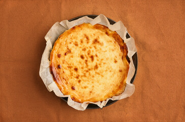 Cheesecake dessert for Thanksgiving. Copy space, flat lay. Basque dessert. Homemade baking. Fall recipe vibes .