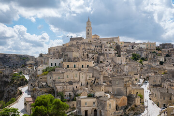 Obraz premium Explore the enchanting ancient stone city of Matera in Puglia, Italy under a dramatic sky
