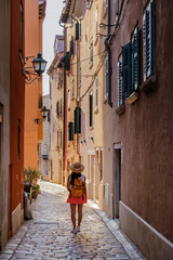 A wanderer exploring the charming streets of Rovinj, Croatia on a sunny afternoon