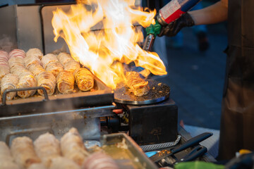 Seller use the culinary torch to melt the cheese on top ,work the flame of a culinary torch lightly...