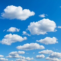 Fototapeta premium A clear blue sky dotted with fluffy white clouds creates a serene and peaceful atmosphere.